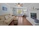 Comfortable living room with brick fireplace, large window, and plush couch at 3007 Appling Way, Durham, NC 27703