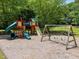 Community playground featuring slides and swings, surrounded by natural landscape at 3007 Appling Way, Durham, NC 27703