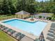 Community pool with a bathhouse and plenty of seating and umbrellas at 3007 Appling Way, Durham, NC 27703