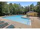 Outdoor pool with seating and a cabana-style building, offering relaxation and convenience at 3007 Appling Way, Durham, NC 27703