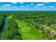 Stunning aerial view of a lush golf course community with beautiful homes and mature trees at 306 Neuse Ridge Dr, Clayton, NC 27527