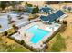 Aerial view of the community pool, clubhouse, and parking, surrounded by manicured landscaping at 306 Neuse Ridge Dr, Clayton, NC 27527