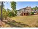 Expansive backyard with lush greenery and a raised deck, perfect for outdoor enjoyment at 306 Neuse Ridge Dr, Clayton, NC 27527