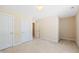 Neutral bedroom featuring multiple doors, neutral walls, and carpeted floors at 306 Neuse Ridge Dr, Clayton, NC 27527