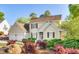 Charming two-story home with a well-manicured lawn and mature landscaping at 306 Neuse Ridge Dr, Clayton, NC 27527