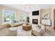 Cozy living room featuring a fireplace, neutral decor, and plenty of natural light at 306 Neuse Ridge Dr, Clayton, NC 27527