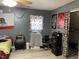This is a picture of the gray bedroom with posters, a microwave, and a window at 3129 Skycrest Dr, Raleigh, NC 27604