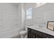 Bathroom featuring a shower and tub and dark vanity with white basin sink at 319 Great Northern Station Sta, Apex, NC 27502