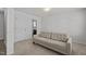 Cozy bedroom featuring neutral walls, carpet flooring, and a comfortable sofa for relaxing at 319 Great Northern Station Sta, Apex, NC 27502