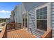 Spacious wooden deck on a light blue home exterior with natural sunlight at 319 Great Northern Station Sta, Apex, NC 27502