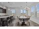 Bright dining area with a modern chandelier, island seating and patio access at 319 Great Northern Station Sta, Apex, NC 27502