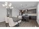 Open dining area with stainless steel appliances and a modern chandelier at 319 Great Northern Station Sta, Apex, NC 27502