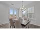Dining area with a modern chandelier, patio access and hardwood floors at 319 Great Northern Station Sta, Apex, NC 27502