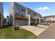Back of townhomes showcasing elevated decks, garages, and driveways at 319 Great Northern Station Sta, Apex, NC 27502
