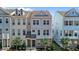 New three-story townhome featuring multi-pane windows and landscaped front yard at 319 Great Northern Station Sta, Apex, NC 27502