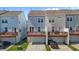 Three-story townhomes with private garages and charming second-story decks at 319 Great Northern Station Sta, Apex, NC 27502