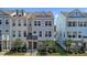 Charming two-story townhome featuring a well-manicured lawn and stylish architectural details at 319 Great Northern Station Sta, Apex, NC 27502
