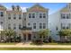 Charming two-story townhome featuring a well-manicured lawn and stylish architectural details at 319 Great Northern Station Sta, Apex, NC 27502