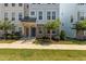 Townhome exterior with brick and blue siding, sidewalk, and tidy landscaping at 319 Great Northern Station Sta, Apex, NC 27502