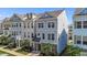 Charming two-story townhome featuring a well-manicured lawn and stylish architectural details at 319 Great Northern Station Sta, Apex, NC 27502