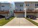 Townhomes featuring elevated decks, garages, and paved driveways at 319 Great Northern Station Sta, Apex, NC 27502