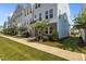 Row of townhomes featuring blue siding, brick facade, and neatly manicured lawns at 319 Great Northern Station Sta, Apex, NC 27502