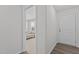 Bright hallway with neutral walls, white trim, and hardwood floors, leading to a cozy living space at 319 Great Northern Station Sta, Apex, NC 27502