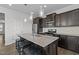Modern kitchen features stainless steel appliances, a center island with seating and hardwood floors at 319 Great Northern Station Sta, Apex, NC 27502