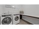 Bright laundry room with modern washer and dryer and folding counter at 319 Great Northern Station Sta, Apex, NC 27502