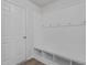Organized mudroom with beadboard, hooks, a bench, and storage cubbies for shoes and essentials at 319 Great Northern Station Sta, Apex, NC 27502