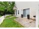 Back of home with mature landscaping, manicured yard, concrete patio with grill, and white picket fence at 320 Gilman Ln # 106, Raleigh, NC 27610