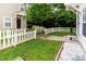 Back of home with manicured yard, walkway, and white picket fence at 320 Gilman Ln # 106, Raleigh, NC 27610
