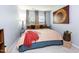 Cozy bedroom with blue walls, warm textiles, and two sunny windows for natural light at 320 Gilman Ln # 106, Raleigh, NC 27610