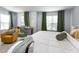 Bright bedroom featuring many windows, a cozy chair, baby furniture, and a queen-sized bed at 320 Gilman Ln # 106, Raleigh, NC 27610