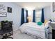 Bright bedroom with large windows, desk, carpet floors and blue curtains at 320 Gilman Ln # 106, Raleigh, NC 27610