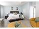 Large bedroom featuring a large bed, two chairs, baby changing table, and windows at 320 Gilman Ln # 106, Raleigh, NC 27610