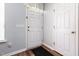 Neutral entryway features a white door and a dark rug on a hardwood floor at 320 Gilman Ln # 106, Raleigh, NC 27610
