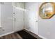 Entryway features gray walls, a white door, a dark rug, and a gold trimmed mirror at 320 Gilman Ln # 106, Raleigh, NC 27610