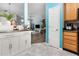 Open-concept kitchen with white cabinets and stainless steel countertops, leading to the living room at 320 Gilman Ln # 106, Raleigh, NC 27610