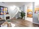 A spacious living room features a fireplace, staircase, and access to the kitchen at 320 Gilman Ln # 106, Raleigh, NC 27610