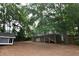 Large backyard features a spacious deck, playhouse, mature trees, and a fully fenced-in area at 3209 Leebrook Rd, Raleigh, NC 27616