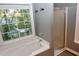 Bright bathroom featuring a soaking tub, window, and glass-enclosed shower at 3209 Leebrook Rd, Raleigh, NC 27616