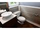 Charming bathroom features new wall treatment, a white vessel sink, and updated fixtures at 3209 Leebrook Rd, Raleigh, NC 27616