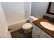 Bathroom features a tub shower combo, granite top vanity and wood look flooring at 3209 Leebrook Rd, Raleigh, NC 27616