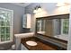 Bathroom with granite vanity, decorative mirror, and storage cabinet at 3209 Leebrook Rd, Raleigh, NC 27616