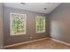 Bedroom with two windows offers ample natural light and neutral walls at 3209 Leebrook Rd, Raleigh, NC 27616