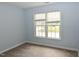 A bright bedroom with neutral carpet paint features a large window at 3209 Leebrook Rd, Raleigh, NC 27616