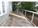 Exterior deck with wood flooring, white railing, and black metal balusters overlooks the backyard at 3209 Leebrook Rd, Raleigh, NC 27616