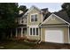 Charming two-story home featuring a two-car garage, manicured lawn, and neutral paint scheme at 3209 Leebrook Rd, Raleigh, NC 27616