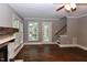 Bright living room with hardwood floors, fireplace, staircase and backyard access at 3209 Leebrook Rd, Raleigh, NC 27616